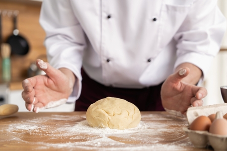 Wheat bread to the oven. The Bakers hands. Process the dough for wheat bread.の写真素材