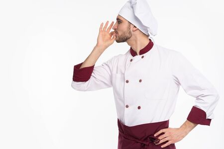 Positive professional happy man chef showing tasty ok sign isolated on white background.の写真素材