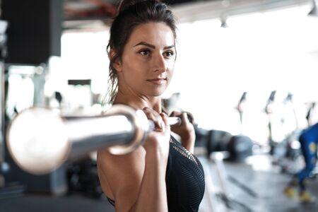 beautiful muscular fit woman exercising building musclesの写真素材