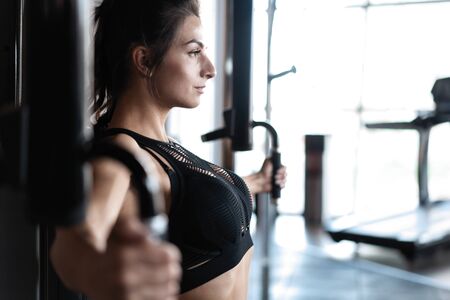 beautiful muscular fit woman exercising building musclesの写真素材