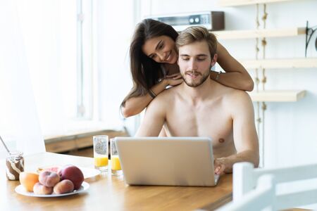 Couple in front laptop computer in the kitchen.の写真素材
