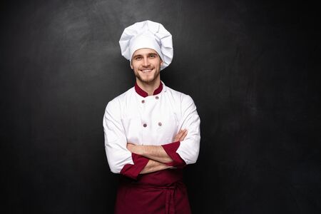 Young male chef isolated on a black background.の写真素材