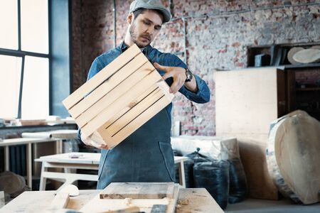 Successful handsome businessman with stylish cap work in carpentry