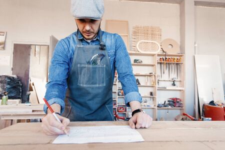 Successful handsome businessman with stylish cap work in carpentry