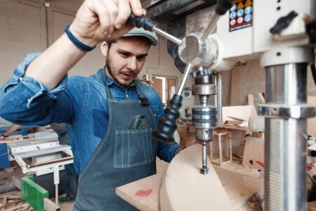Successful handsome businessman with stylish cap work in carpentryの写真素材