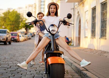 Couple in love riding a motorbike , Handsome guy and young sexy woman travel . Young riders enjoying themselves on trip. Adventure and vacations concept.の写真素材