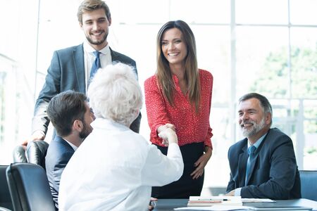 Business people shaking hands, finishing up a meeting.の写真素材
