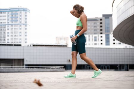 Beautiful fitness girl in sportswear resting after workout session. Concept of sport, wellness and health.の写真素材