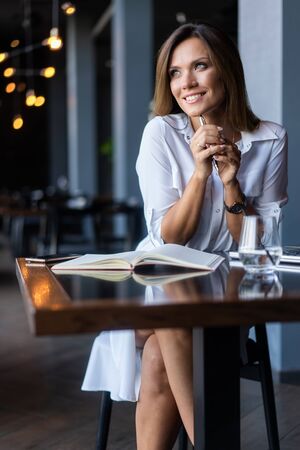 woman drinking coffee in the morning at restaurantの写真素材