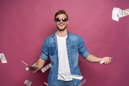 Concept of financial wealth, prosperity and lottery winnings - Man throwing away his money isolated...
