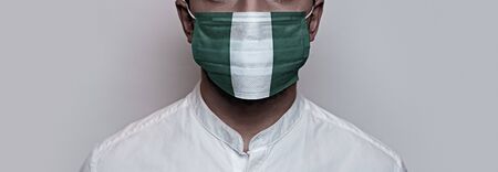 Corona virus pandemic. Concept of Corona virus quarantine, Covid-19. The male face is covered with a medical maskの写真素材