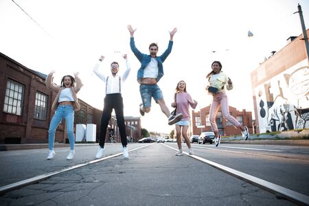 Group of young people having fun together outdoors in urban background.の写真素材