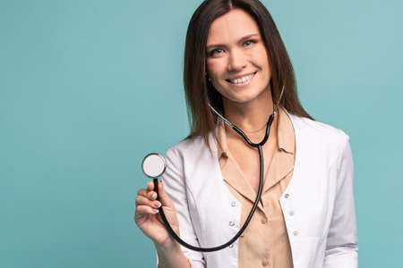 Young, smart and professional doctor isolated on light blue.の写真素材