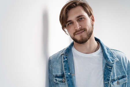 Fashion portrait of young man wearing jeans jacket.