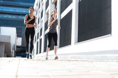 Fit women in sport clothing jogging outdoors and living a healthy lifestyleの写真素材