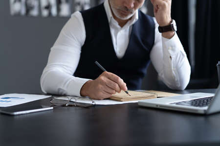 Businessman working with documents in the office. Financial planning specialist signing annual...