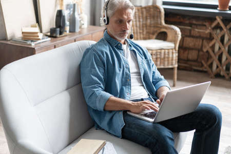 Smiling male call center agent or telemarketer work consult client online, good customer service...