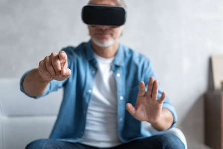 Handsome man trying vr glasses at home.の写真素材