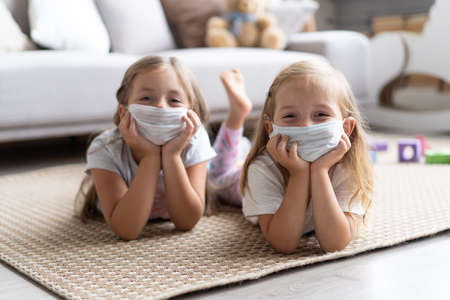 Kids children wearing mask for protect Covid-19. Stay at home quarantine for coronavirus pandemic preventionの写真素材