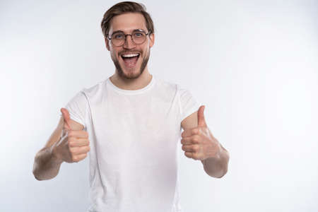 Happy man giving thumbs up sign isolated on white background.の写真素材
