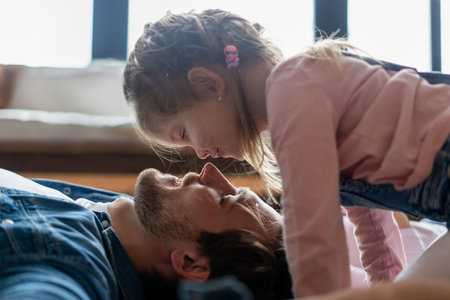happy family and fathers day. child daughter kissing and hugging dad.の写真素材