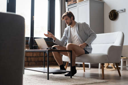 Male remote working from home and having work confrence video call.の写真素材