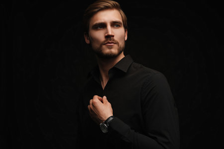 Elegant young handsome man in black suit. Studio fashion portraitの写真素材