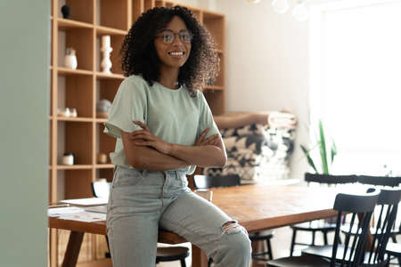 Portrait of happy, smiling mixed race businesswoman in her office.