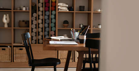 Modern creative workplace with laptop notebook mock up white empty screen on desk at work space office room interiorの写真素材