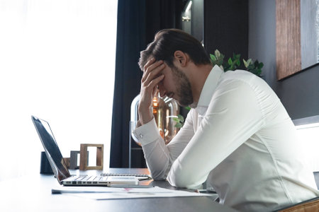Frustrated stressed businessman feel tired having migraine during working at office. Exhausted man having headache and problem about his financial. Unemployment, Business Economic Crisisの写真素材