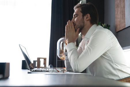 Frustrated stressed businessman feel tired having migraine during working at office. Exhausted man having headache and problem about his financial. Unemployment, Business Economic Crisisの写真素材
