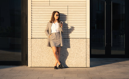 Successful businesswoman standing over modern office background, startup and business conceptの写真素材