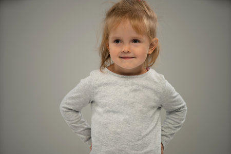 Portrait of a happy smiling child girl isolated over white background. Copy space for adの写真素材
