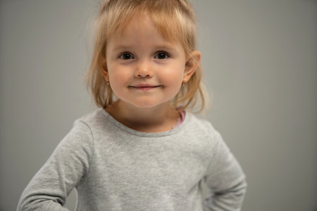 Portrait of a happy smiling child girl isolated over white background. Copy space for adの写真素材