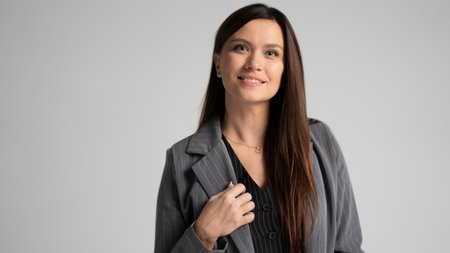 Classic portrait of business woman in a gray jacket isolated studio portrait. Happy successful employee businesswoman corporate lawyer 30sの写真素材