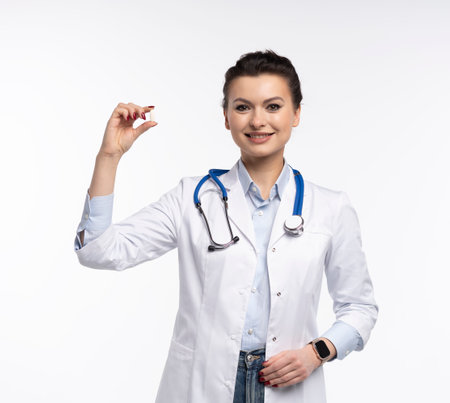 Photo of charming attractive woman qualified specialist therapist wear white doctor robe hand hold pills isolated on white backgroundの写真素材