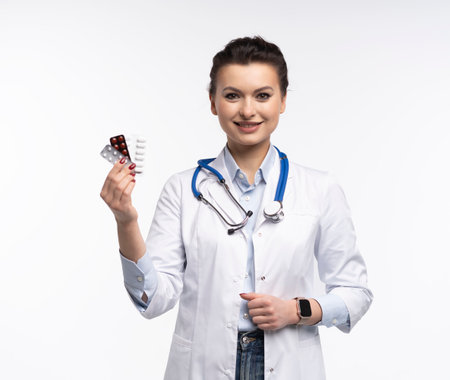 Photo of charming attractive woman qualified specialist therapist wear white doctor robe hand hold pills isolated on white backgroundの写真素材