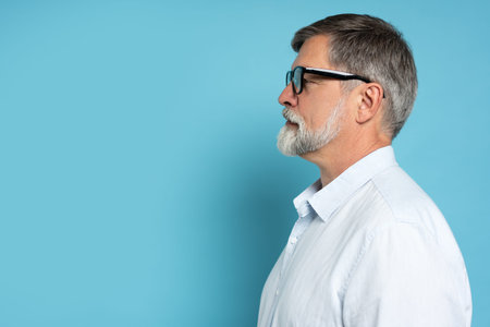 Side profile close up photo of successful mature handsome brunet bearded businessman in formal...