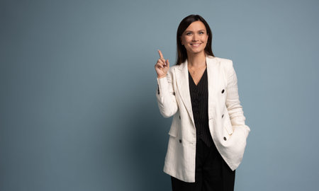 Happy smiling professional business woman looking at camera pointing finger away at copy space...