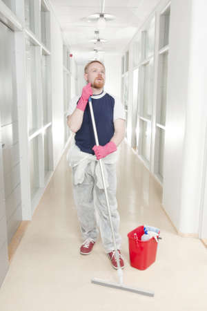 Man Stopped at Wondering in middle of Corridor Cleaningの写真素材