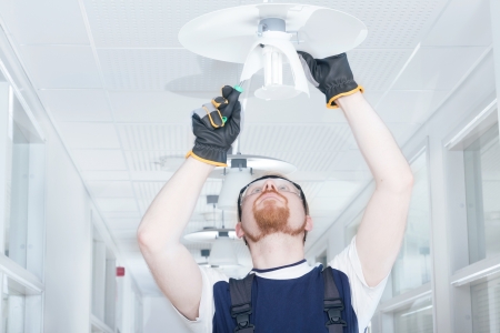 Man Fixing Lampの写真素材