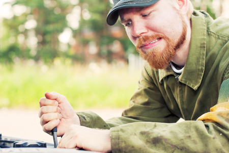 Man Carefully Wringing With Wrench