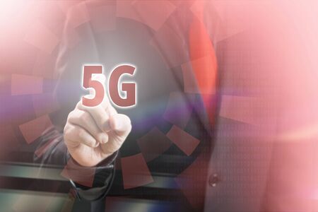Businessman Pointing 5G Icon in Communication Concept Imageの写真素材