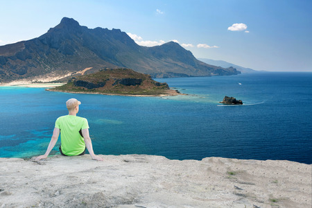 Runner Man Having a Break with Beautiful View Over Mediterranean Coastlineの写真素材