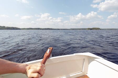 View Backwards of Hand Steering Small Boatの写真素材