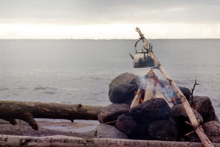 Cooking Water for Campfire Coffee with View to Sea