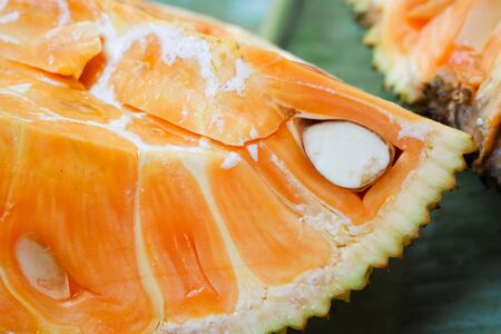 Orange Jackfruit placed on banana leaves.