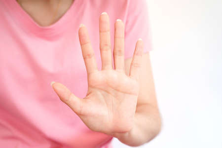 Close-up female hand showing stop sign with five fingers spread, sign language concept.