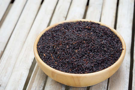 Riceberry in a wooden cup on the table healthy eating concept.の写真素材