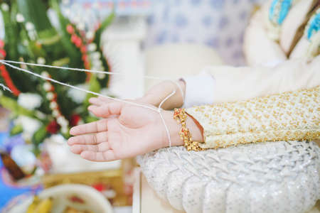 Married couples tied the wrist,Thai traditional wedding ceremony, wedding ceremony in thailand.の写真素材